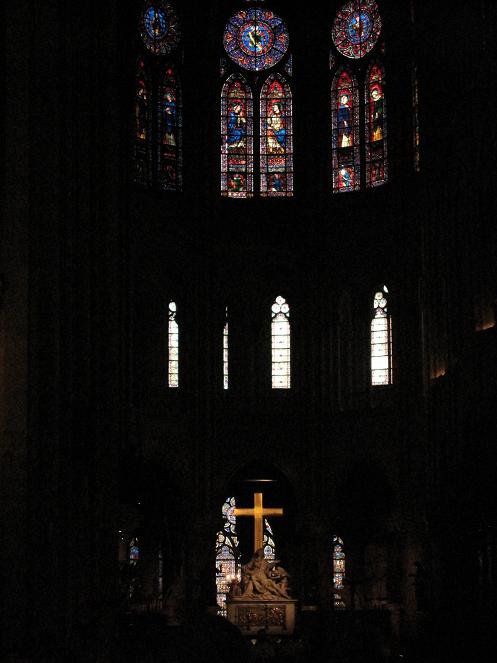 Inside Notre Dame. It felt like an eternal (yet spiritually soothing) night, and the cross beckoned to me with its cold glow to take a picture. I gave in.